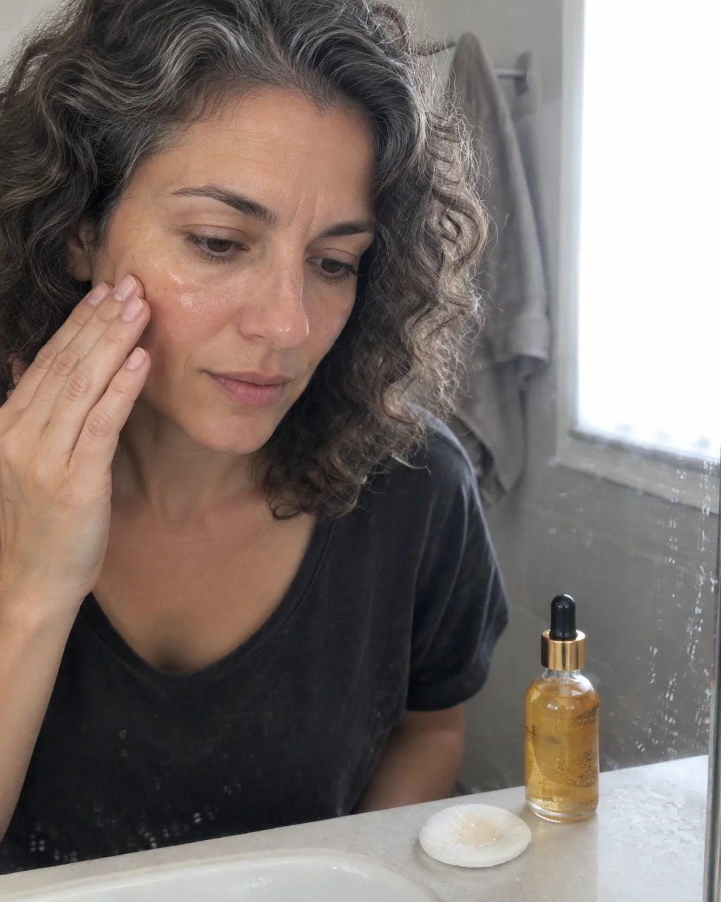 A customer's own close photo taken by a friend in a lived-in bathroom after application. A 42-year-o